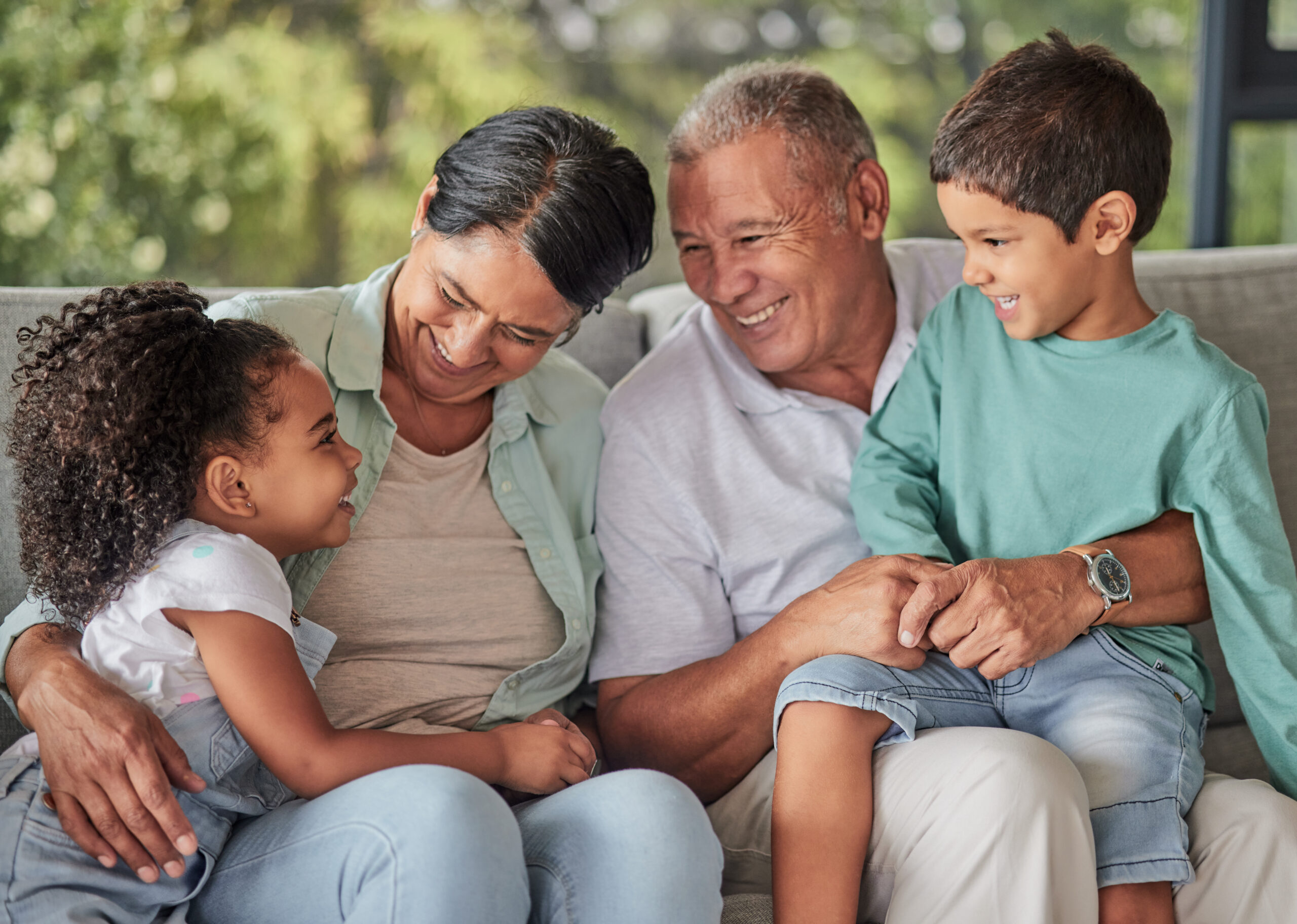 A diverse family sitting closely together on a couch, showcasing a warm, supportive environment that could represent the comprehensive care provided by Universal Health Centre.